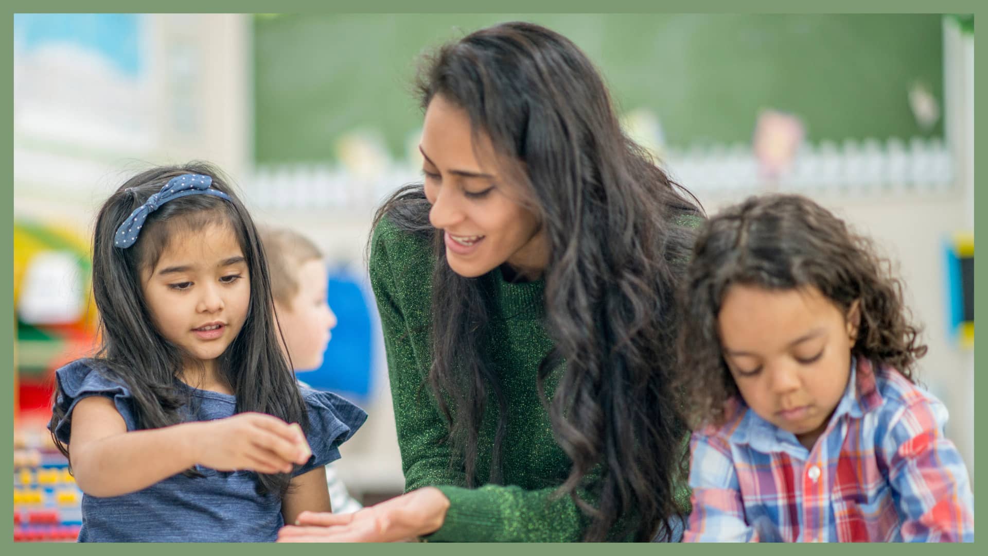 Teacher interacting with two young children during a classroom learning activity.