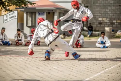 Two boys are practicing the Taekwondo